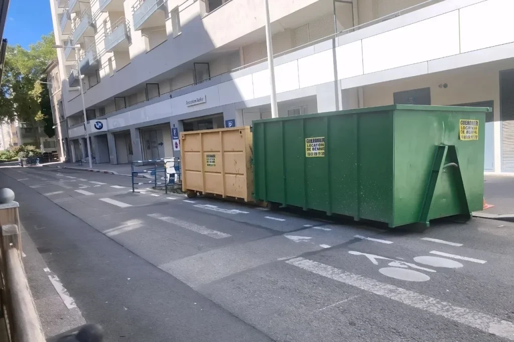 Deux bennes Guerdner, une verte et une jaune, posées le long d'une rue pour un chantier à Lyon